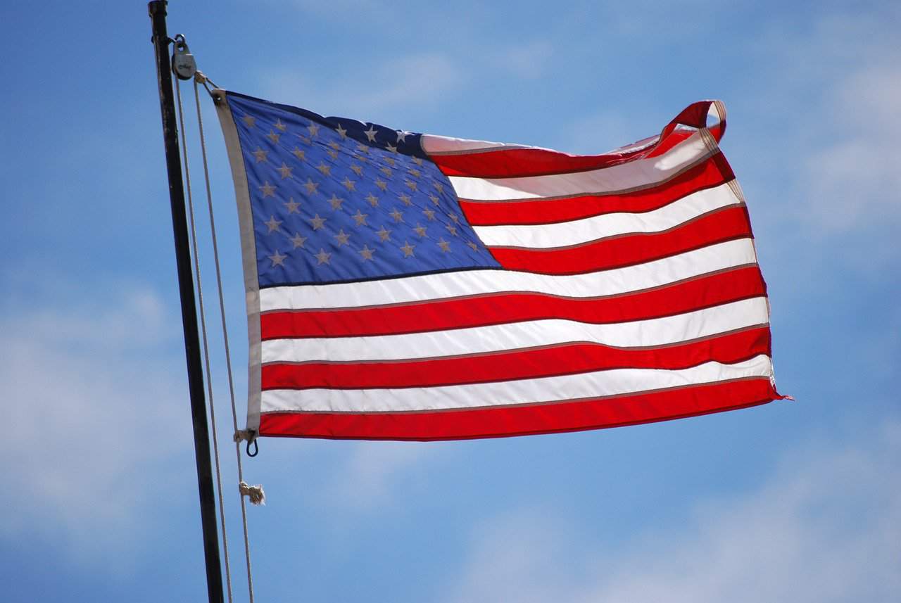 American flag waving against blue sky