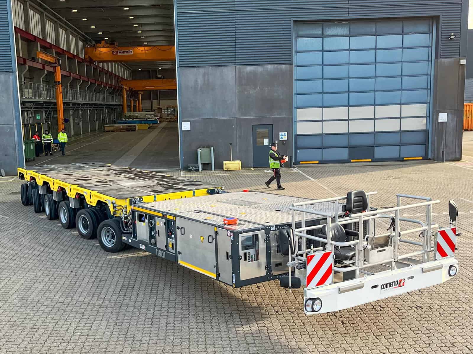 Large industrial flatbed trailer outside warehouse