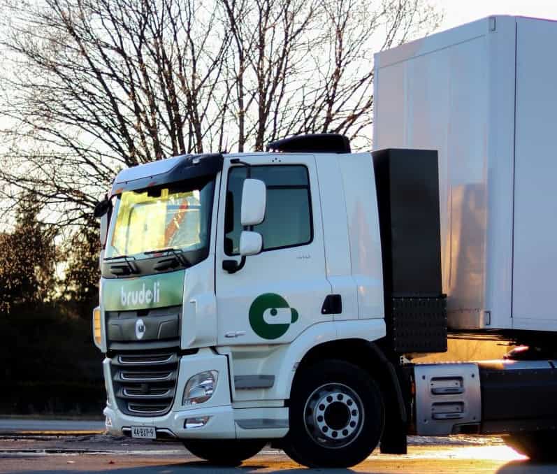 White truck with modern design parked outdoors.