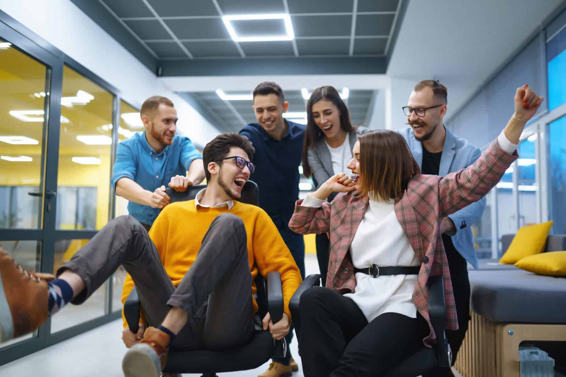 Office colleagues having fun with chairs