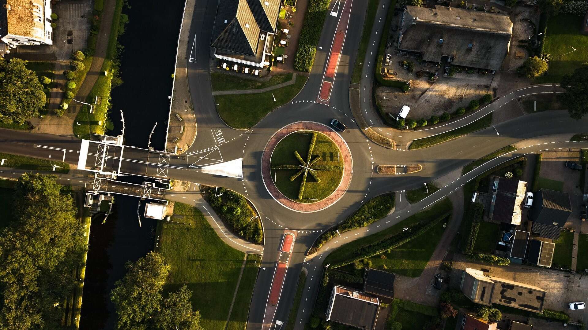 Aerial view of a roundabout with roads and buildings.